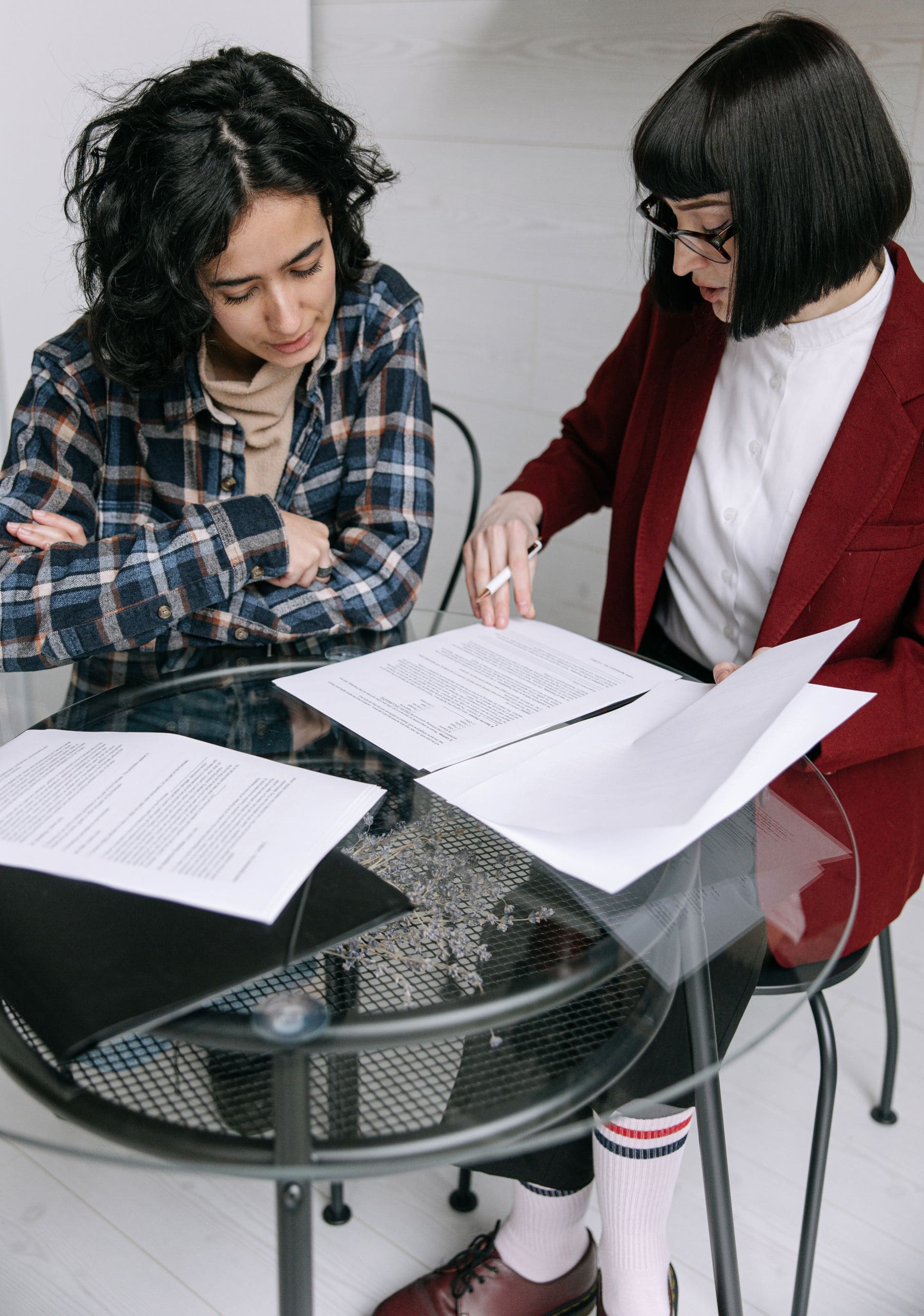 Two women reviewing organizational documents in a focused working session